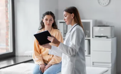 Young woman talks to her doctor about managing side effects