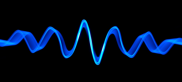 Blue sound wave against a black background.